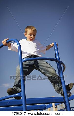 Boy climbing in playground View Large Photo Image Stock Photo - Boy climbing in playground. Fotosearch