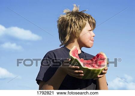 Boy eating watermelon View Large Photo Image Stock Image - Boy eating watermelon. Fotosearch