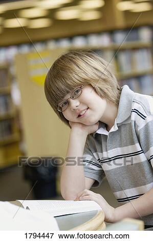 Stock Photo - Boy in a library. Fotosearch