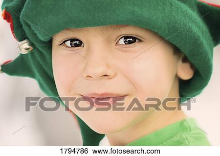 Stock Photograph - Boy wearing a festive hat. Fotosearch