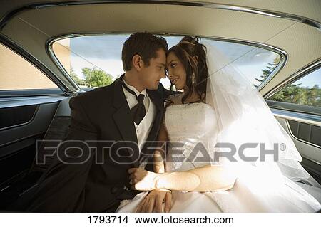 Bride and groom inside wedding car View Large Photo Image Picture - Bride and groom inside wedding car. Fotosearch