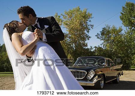 Stock Image - Bride and groom kissing. Fotosearch
