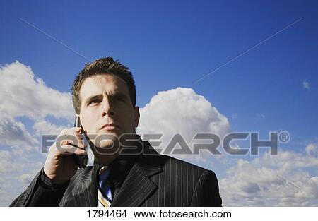 Picture - Businessman on cell phone. Fotosearch