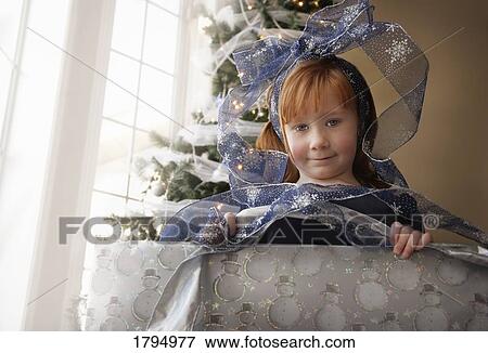 Stock Photo - Child inside Christmas present. Fotosearch