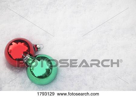 Stock Photo - Christmas ornaments in snow. Fotosearch
