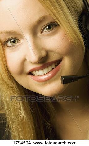 Picture - Closeup of a woman with a head set. Fotosearch