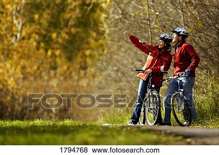 Stock Photo - Couple on bicycles. Fotosearch