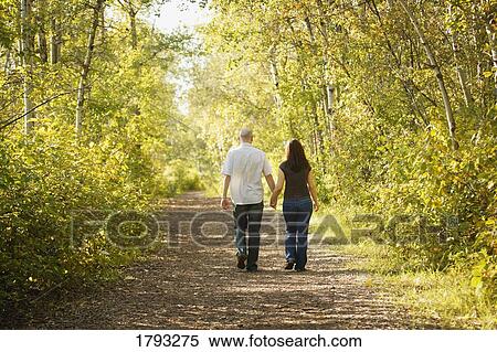 Couple walking down path together View Large Photo Image Stock Photography - Couple walking down path together. Fotosearch
