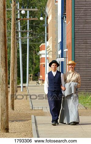 Stock Photograph - Couple walking down the street. Fotosearch