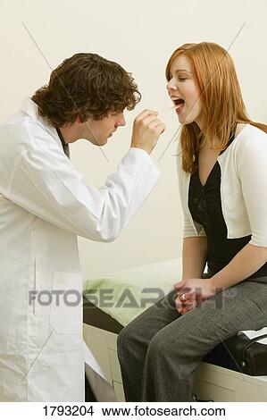 Doctor examines woman View Large Photo Image Picture - Doctor examines woman. Fotosearch