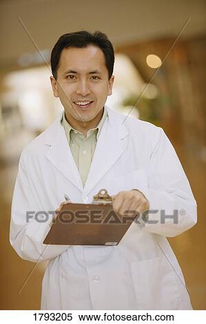 Stock Photography - Doctor with clipboard. Fotosearch