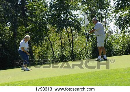 Elderly couple playing golf View Large Photo Image Stock Image - Elderly couple playing golf. Fotosearch