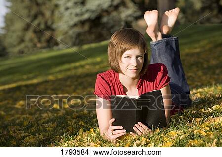 Female reading outdoors View Large Photo Image Picture - Female reading outdoors. Fotosearch