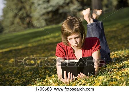 Female reading outdoors View Large Photo Image Stock Image - Female reading outdoors. Fotosearch