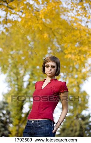Stock Photo - Female wearing sunglasses. Fotosearch
