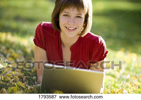 Female working on a laptop View Large Photo Image Stock Photo - Female working on a laptop. Fotosearch