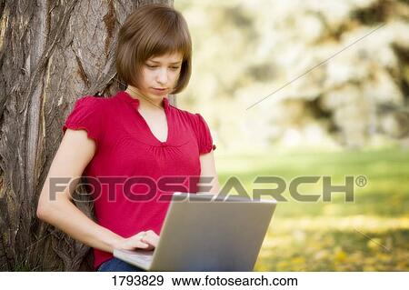 Female working on a laptop View Large Photo Image Stock Photo - Female working on a laptop. Fotosearch