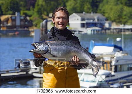 Fisherman holding catch View Large Photo Image Stock Photography - Fisherman holding catch. Fotosearch