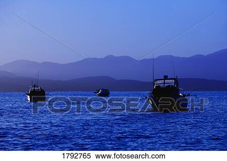 Fishing boats at sea View Large Photo Image Stock Photography - Fishing boats at sea. Fotosearch