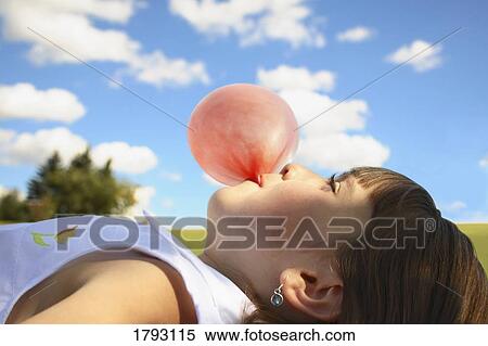 Stock Photography - Girl blowing bubblegum. Fotosearch