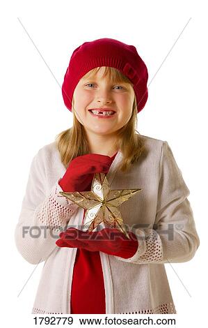 Girl holding a Christmas star View Large Photo Image Stock Photo - Girl holding a Christmas star. Fotosearch