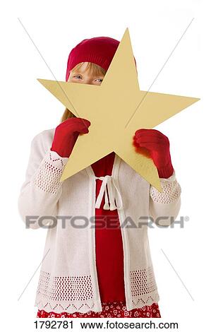 Girl in red hat and mitts holding gold star View Large Photo Image Stock Image - Girl in red hat and mitts holding gold star. Fotosearch