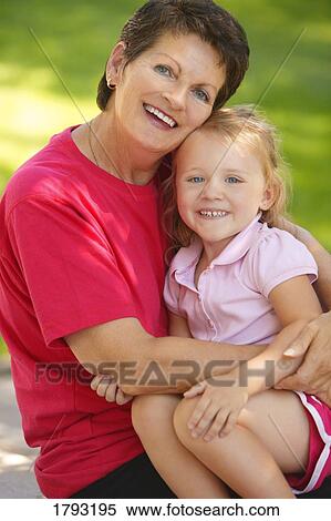 Stock Photography - Girl sitting with grandmother. Fotosearch
