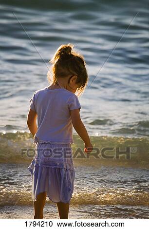 Girl wading in the water View Large Photo Image Stock Image - Girl wading in the water. Fotosearch