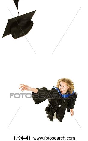 Stock Image - Graduate throwing her cap. Fotosearch