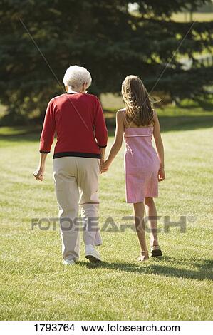 Picture - Grandmother and granddaughter holding hands. Fotosearch