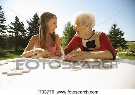 Grandmother and granddaughter playing a game View Large Photo Image Stock Photograph - Grandmother and granddaughter playing a game. Fotosearch