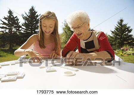 Grandmother and granddaughter playing a game View Large Photo Image Stock Photography - Grandmother and granddaughter playing a game. Fotosearch