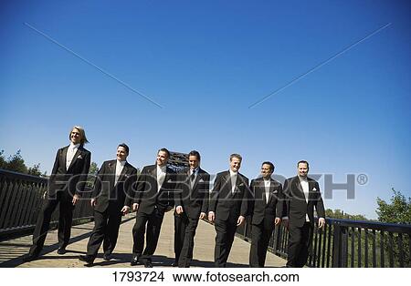 Picture - Groomsmen walking over a bridge. Fotosearch