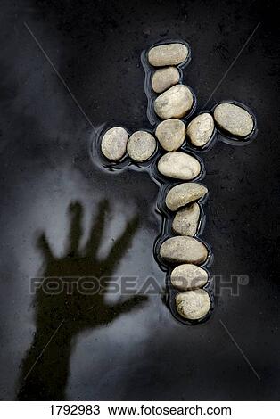 Hand reaching over water for cross made of rocks View Large Photo Image Stock Image - Hand reaching over water for cross made of rocks. Fotosearch