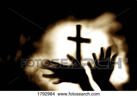 Picture - Hands and cross. Fotosearch