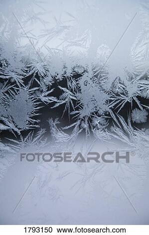Stock Image - Ice crystals on glass. Fotosearch