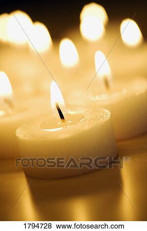 Stock Photo - Lit candles. Fotosearch