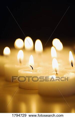 Stock Photo - Lit candles. Fotosearch