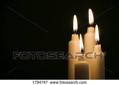 Stock Photo - Lit candles. Fotosearch