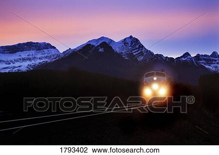 Stock Image - Locomotive train at night. Fotosearch