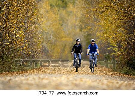 Man and woman biking View Large Photo Image Stock Photo - Man and woman biking. Fotosearch