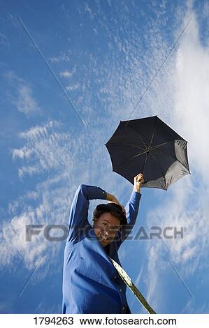 Man being carried away by umbrella View Large Photo Image Stock Image - Man being carried away by umbrella. Fotosearch