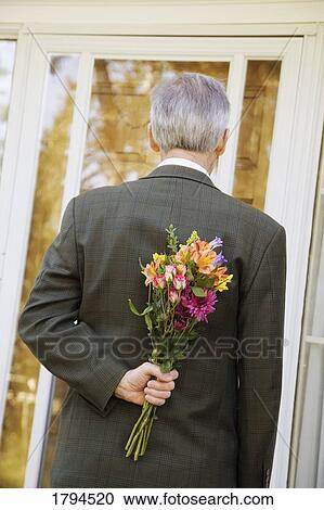 Man bringing flowers View Large Photo Image Stock Image - Man bringing flowers. Fotosearch