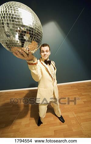 Man holding a disco ball View Large Photo Image Picture - Man holding a disco ball. Fotosearch