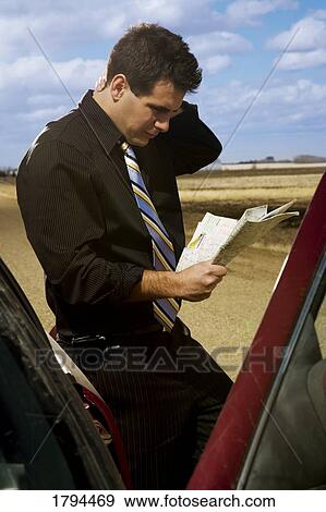 Stock Photo - Man looking at a road map. Fotosearch