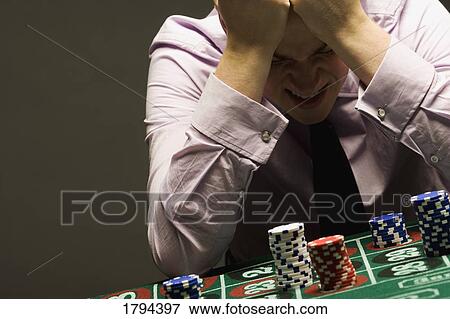 Stock Photo - Man losing at roulette. Fotosearch