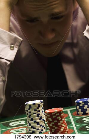 Stock Photo - Man losing at roulette. Fotosearch