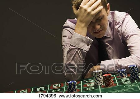 Stock Photograph - Man losing at roulette. Fotosearch