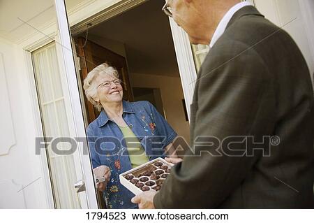 Man offering a box of chocolates to woman View Large Photo Image Stock Image - Man offering a box of chocolates to woman. Fotosearch