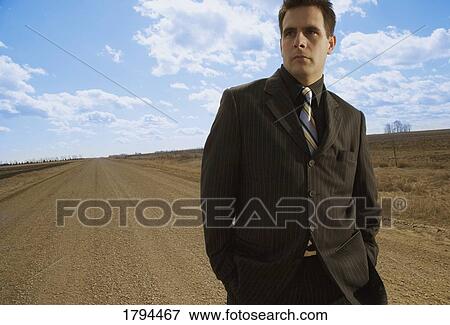 Stock Photo - Man on gravel road. Fotosearch